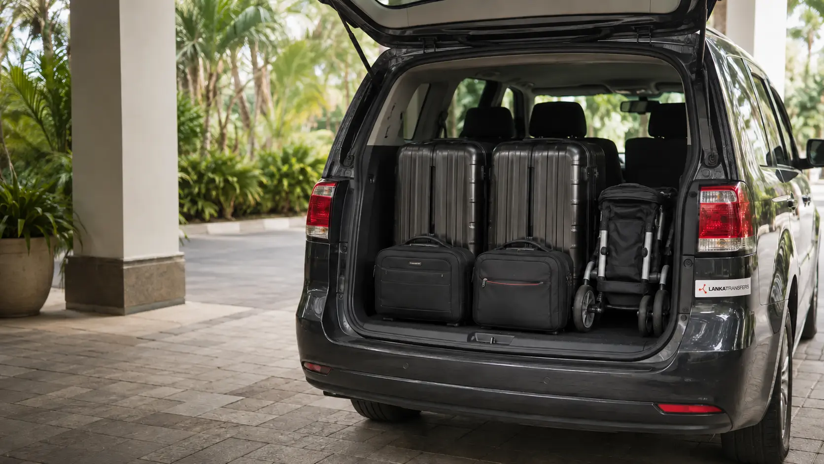 Two large cases, two cabin bags and a folded pushchair arranged inside a private transfer vehicle